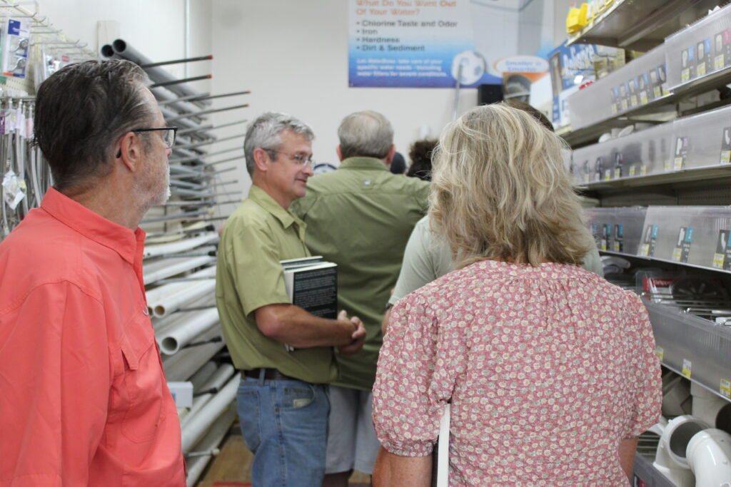 Readers wait during the Fish Days signing of Lansing Locals, held inside the former Allamakee Journal building in Lansing. Photo: Deliverance Hope / Word ’Round Town.
